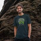 Man stood against rocks wearing a Denim Blue Mix Tape Army organic cotton t-shirt