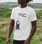 Man stood in the countryside near the sea wearing a White  How Long Before The Robots Attack Graphic T-Shirt